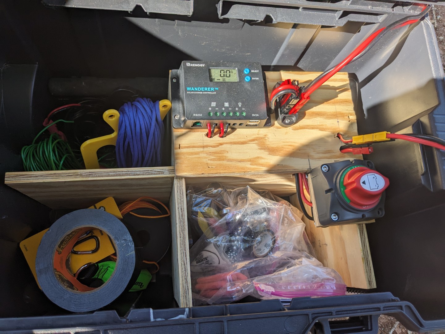 The plywood divider in the roll-around case, holding the battery and organizing the field supplies.